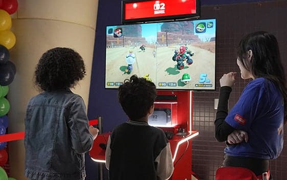 People playing a Nintendo Switch racing game at an interactive lobby activation