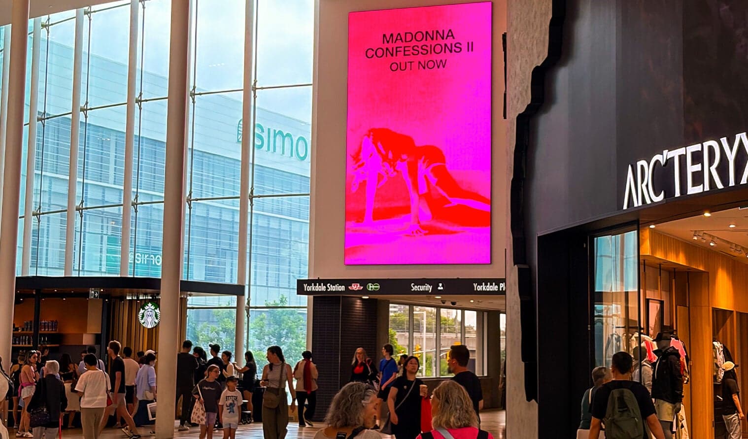 Large digital screen in Yorkdale mall displaying Warner Music Canada advertisement